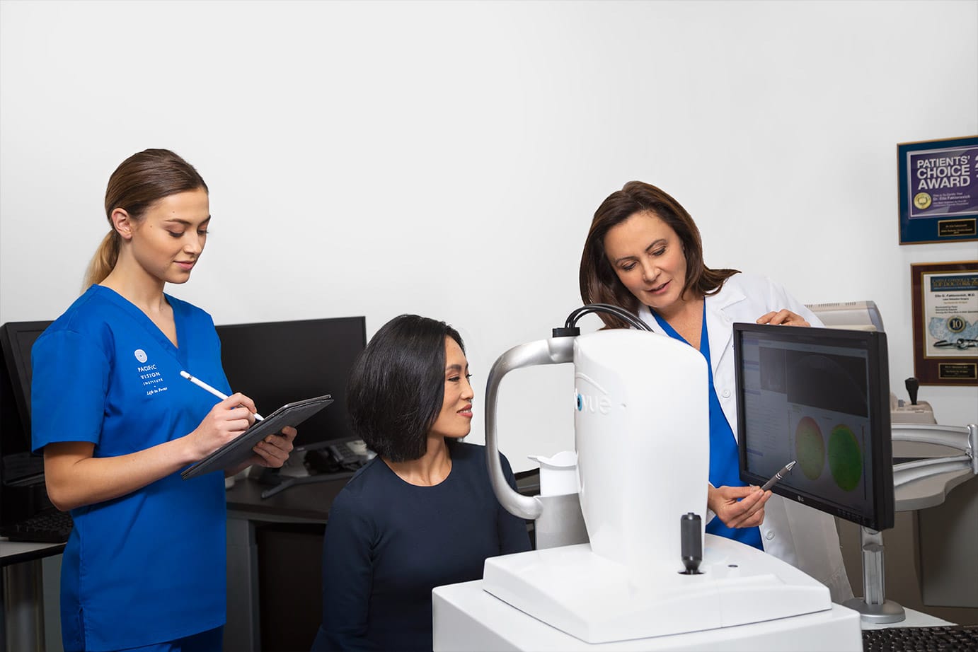 Dr. Faktorovich showing a patient a picture of the back of her eye