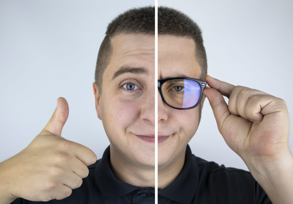 Man giving thumbs up and holding glasses