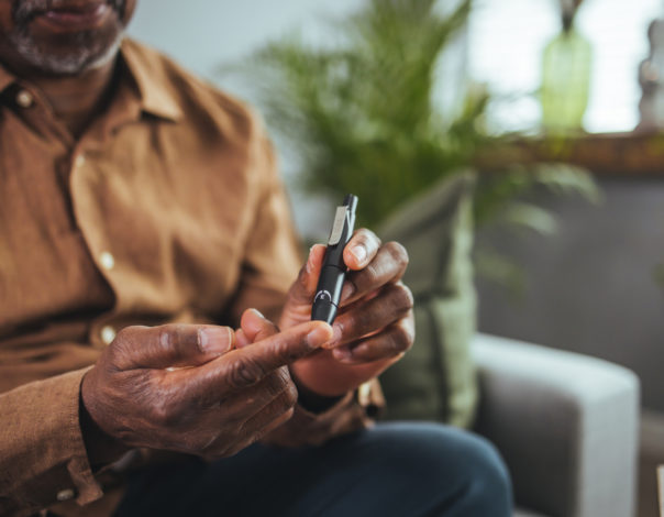 Everyday life of a man of African American nationality with a chronic disease who uses a glucose tester.