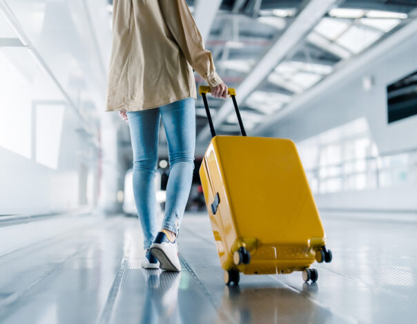 Woman dragging suitcase in airport